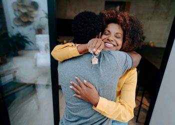 couple hugs as they understand and receive a bridge loan